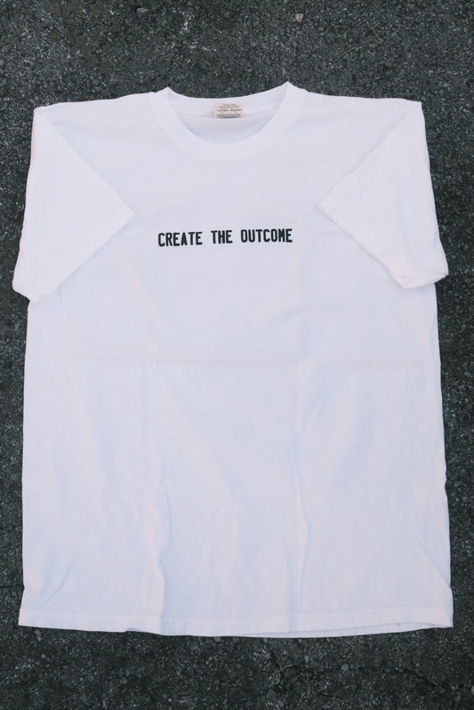 WHITE CREATE THE OUTCOME SHIRT